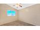 Neutral bedroom featuring a ceiling fan, and a window offering natural light at 1909 N 106Th Ave, Avondale, AZ 85392