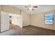 Second level bedroom with vaulted ceiling, ceiling fan, and an open doorway at 1909 N 106Th Ave, Avondale, AZ 85392