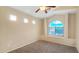 Bedroom showcasing neutral color palette, plush carpeting and arched window at 1909 N 106Th Ave, Avondale, AZ 85392