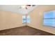 Bright bedroom with neutral walls, carpeting, and a vaulted ceiling with fan at 1909 N 106Th Ave, Avondale, AZ 85392