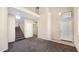 A welcoming two-story entryway featuring carpeted stairs and neutral walls, offering a view into the home's layout at 1909 N 106Th Ave, Avondale, AZ 85392