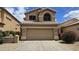 Charming two-story home featuring a two-car garage and a well-maintained desert landscape under a sunny sky at 1909 N 106Th Ave, Avondale, AZ 85392