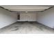 Empty two car garage featuring concrete floors and white walls at 1909 N 106Th Ave, Avondale, AZ 85392
