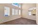 Bright, airy living room with a fireplace, neutral walls, carpeted floors, and multiple windows letting in natural light at 1909 N 106Th Ave, Avondale, AZ 85392