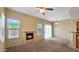 Comfortable living room featuring a fireplace, windows, and a sliding door leading to the outside, perfect for relaxation at 1909 N 106Th Ave, Avondale, AZ 85392