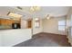 Open concept living room featuring a ceiling fan and adjacent breakfast bar at 1909 N 106Th Ave, Avondale, AZ 85392