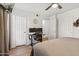 Cozy bedroom with wood flooring, a ceiling fan, and a workstation at 200 E Southern Ave # 133, Tempe, AZ 85282
