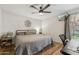 Inviting bedroom features a ceiling fan, wood floors, and a comfortable sleeping space at 200 E Southern Ave # 133, Tempe, AZ 85282