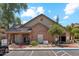 Charming clubhouse exterior features brick accents, manicured landscaping, and reserved parking spaces for residents at 200 E Southern Ave # 133, Tempe, AZ 85282
