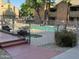 Fenced community pool with clear water, lounge chairs, and grassy area surrounded by residences at 200 E Southern Ave # 133, Tempe, AZ 85282