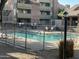 View of community pool with fencing, lounge chairs, building exterior, and desert landscaping at 200 E Southern Ave # 133, Tempe, AZ 85282