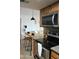 Modern kitchen with stainless steel appliances, breakfast bar seating, and ample natural light at 200 E Southern Ave # 133, Tempe, AZ 85282