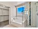 Bathroom featuring a soaking tub and separate glass shower at 2418 W White Feather Ln, Phoenix, AZ 85085
