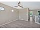 Spacious bedroom featuring wood-look floors, a ceiling fan, and natural light at 2418 W White Feather Ln, Phoenix, AZ 85085