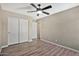 Neutral bedroom featuring hardwood floors, and a ceiling fan at 2418 W White Feather Ln, Phoenix, AZ 85085