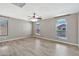 Neutral bedroom featuring hardwood floors and large arched windows at 2418 W White Feather Ln, Phoenix, AZ 85085