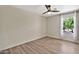 Bright bedroom featuring a ceiling fan, window, and wood-look floors at 2418 W White Feather Ln, Phoenix, AZ 85085