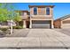 Inviting two-story home showcasing a well-maintained front yard and a spacious two-car garage at 2418 W White Feather Ln, Phoenix, AZ 85085