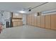 Spacious garage featuring built-in cabinets and epoxy flooring for organized storage and functionality at 2418 W White Feather Ln, Phoenix, AZ 85085