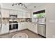Kitchen showcasing stainless steel appliances, granite countertops, and a stainless steel sink at 2418 W White Feather Ln, Phoenix, AZ 85085