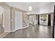 Open living area with staircase and a view into the entry, featuring neutral tones and tile flooring at 2418 W White Feather Ln, Phoenix, AZ 85085