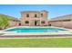 Sparkling pool and landscaped backyard provides a private outdoor oasis with lush lawn at 2418 W White Feather Ln, Phoenix, AZ 85085