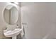 Cozy powder room featuring a pedestal sink and stylish decor at 2418 W White Feather Ln, Phoenix, AZ 85085