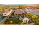 Aerial view of an impeccably landscaped backyard featuring outdoor living areas, green spaces, and a pergola at 26065 N 74Th Dr, Peoria, AZ 85383