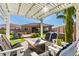 Inviting backyard with a pergola, fire pit, and comfortable seating for relaxing outdoor living at 26065 N 74Th Dr, Peoria, AZ 85383