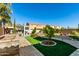 Expansive backyard featuring lush artificial turf, a stone-paved pathway, and mature landscaping at 26065 N 74Th Dr, Peoria, AZ 85383