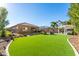 Large backyard with artificial turf, a pergola, and an outdoor living area for comfortable entertaining at 26065 N 74Th Dr, Peoria, AZ 85383