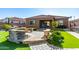 Spacious backyard with seating, a fire pit, a lawn, and mature landscaping for outdoor enjoyment at 26065 N 74Th Dr, Peoria, AZ 85383