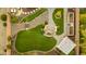 Aerial view of an immaculate backyard featuring artificial turf, a rock garden and a cozy fire pit area at 26065 N 74Th Dr, Peoria, AZ 85383
