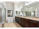 A primary bathroom features granite counters, tile floor, bath tub and glass enclosed shower at 26065 N 74Th Dr, Peoria, AZ 85383