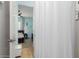 The bathroom leads to the bedroom featuring light blue walls and a ceiling fan at 26065 N 74Th Dr, Peoria, AZ 85383