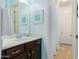 The bathroom has dark cabinets with granite counter tops and framed wall art at 26065 N 74Th Dr, Peoria, AZ 85383