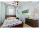 A bedroom features a ceiling fan, plantation shutters and light blue walls at 26065 N 74Th Dr, Peoria, AZ 85383