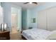 A bedroom features a ceiling fan, plantation shutters and light blue walls at 26065 N 74Th Dr, Peoria, AZ 85383
