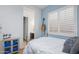 Bright bedroom with ensuite bathroom, featuring shutters and a decorative cabinet at 26065 N 74Th Dr, Peoria, AZ 85383