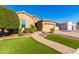 Charming single-Gathering home with lush landscaping, a paved walkway, and an attached two-car garage at 26065 N 74Th Dr, Peoria, AZ 85383