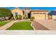 Charming home showcasing a well-manicured lawn, mature trees, and a warm color palette at 26065 N 74Th Dr, Peoria, AZ 85383