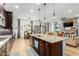 Open-concept kitchen with granite island, stainless appliances, and view into living area at 26065 N 74Th Dr, Peoria, AZ 85383