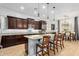 Modern kitchen with granite countertops, stainless steel appliances, and a breakfast bar at 26065 N 74Th Dr, Peoria, AZ 85383