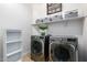 Well-equipped laundry room with front load washer and dryer, and ample shelving at 26065 N 74Th Dr, Peoria, AZ 85383