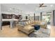 Bright and airy living area with a sectional sofa, stylish rug, and seamless flow into the kitchen at 26065 N 74Th Dr, Peoria, AZ 85383