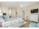 Serene main bedroom with an ensuite bathroom and a large dresser at 26065 N 74Th Dr, Peoria, AZ 85383