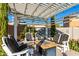Elegant backyard pergola with comfortable seating and a modern fire pit for outdoor relaxation at 26065 N 74Th Dr, Peoria, AZ 85383