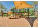 Neighborhood playground featuring slides, climbing structures, and a sunshade, set on a sandy surface at 26065 N 74Th Dr, Peoria, AZ 85383