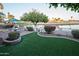Picturesque backyard with artificial turf, seating, and stunning water views at 2635 N 62Nd St, Mesa, AZ 85215