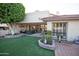 Beautiful backyard with artificial grass, patio area, and privacy landscaping at 2635 N 62Nd St, Mesa, AZ 85215